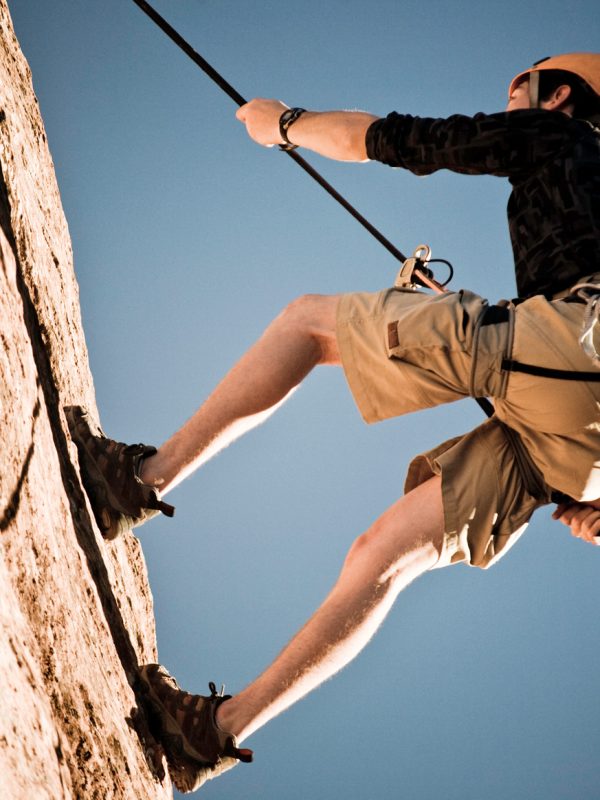 A young man in 20s rappelling in Utah.Our images are processed from